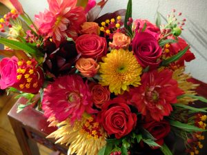 Golden mums, old gold spider mums, 3 kinds of roses, dahlias, leucadendron & asclepias in a riot of fall colours.