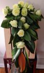 This cascade bridal bouquet of Jade roses, magnolia leaves, and hypericum conveys Southern elegance.
