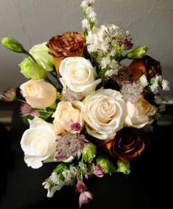 This bouquet is entitled "Sophistication." It was held by the mother of the groom. Astrantia, white statice, green lisianthus, vendela roses, mocchachino roses reflect the mature refinement of its bearer.